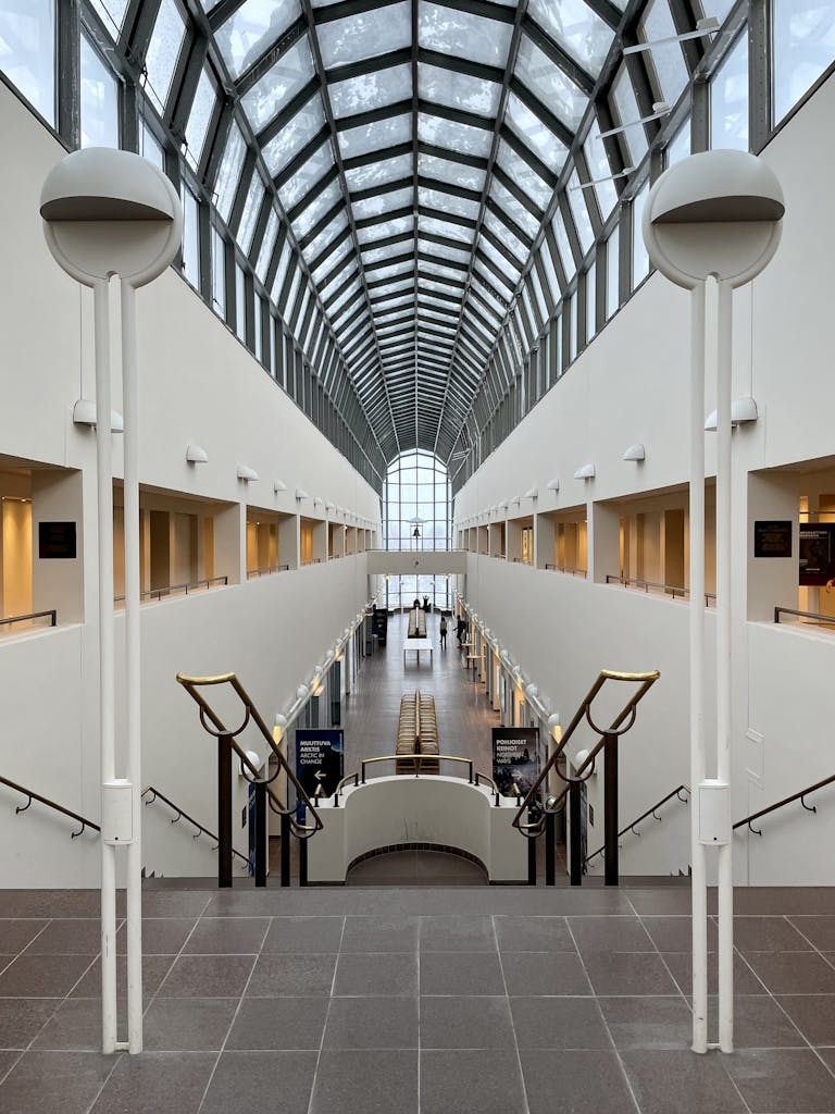 A stunning architectural atrium with a glass ceiling in Rovaniemi's modern building.